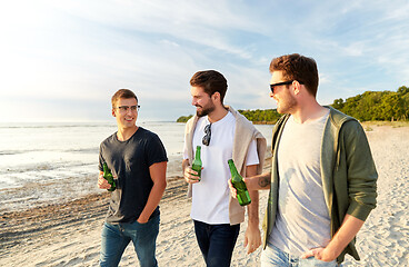 Image showing young men with non alcoholic beer walking on beach