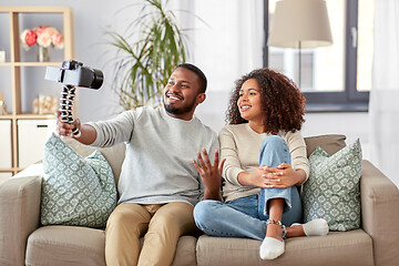 Image showing couple of video bloggers with camera at home