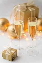 Image showing glasses of champagne and christmas gifts