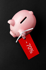 Image showing piggy bank with red sale tag on black