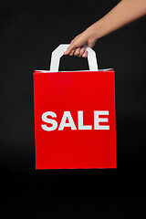 Image showing hand holding red shopping bag with sale word