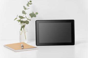 Image showing tablet pc with black screen on white office table