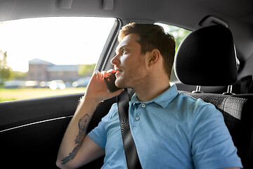 Image showing male passenger calling on smartphone in taxi car