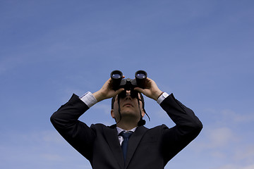 Image showing Businessman looking through binoculars