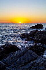 Image showing Sunset on the rocky shore.