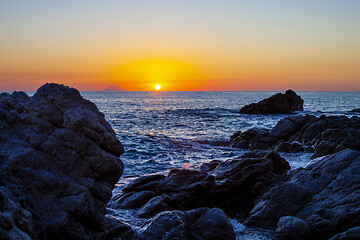 Image showing Sunset on the rocky shore. 