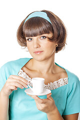 Image showing Portrait of young woman in blak dress enjoying a cup of coffee.