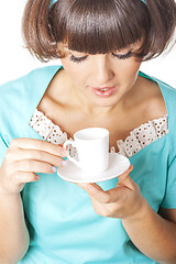 Image showing Portrait of young woman in blak dress enjoying a cup of coffee.