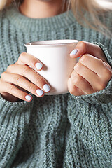 Image showing Young woman relaxing tea cup on hands.