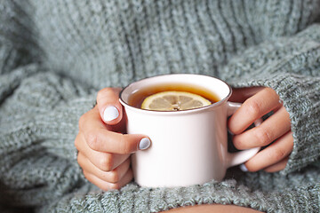 Image showing  Young woman relaxing tea cup on hands.