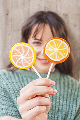 Image showing Pretty young happy woman posing with sweet lollipops. 