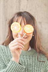 Image showing Pretty young happy woman posing with sweet lollipops.