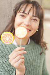 Image showing Portrait of pretty young happy woman posing with sweet lollipops