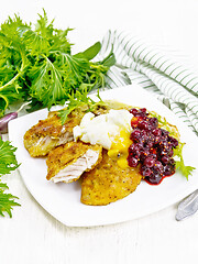 Image showing Turkey breast with cranberry sauce on wooden board