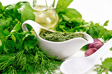 Image showing Sauce of spicy greens in gravy boat on light board