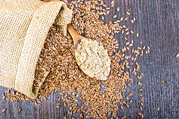 Image showing Flour flax in spoon with seeds on board top