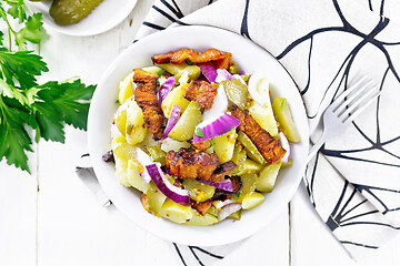 Image showing Salad potato with bacon and cucumber in plate on board top