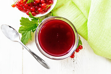 Image showing Jam of red currant in jar on board top