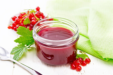 Image showing Jam of red currant in jar on board