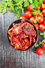 Image showing Tomatoes sun-dried in bowl on dark board top