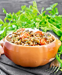 Image showing Lentils with eggplant and tomatoes in bowl on towel