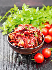 Image showing Tomatoes sun-dried in bowl on black board