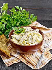 Image showing Salad with squid and champignons in bowl on table