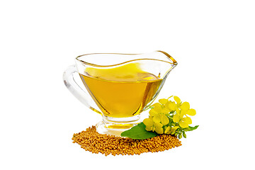 Image showing Oil mustard in gravy boat with seeds and flower