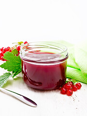 Image showing Jam of red currant in jar on white board