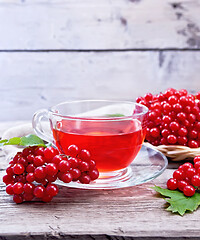 Image showing Tea from viburnum in cup on old board