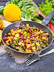 Image showing Mangold braised in pan on black wooden board