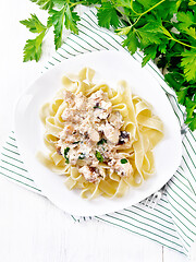 Image showing Pasta with salmon in cream on white board top