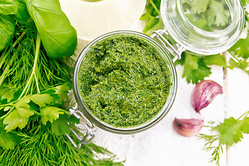 Image showing Sauce of spicy greens in jar on light board top