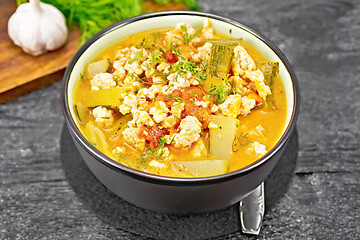 Image showing Ragout of zucchini and minced meat in bowl on black board