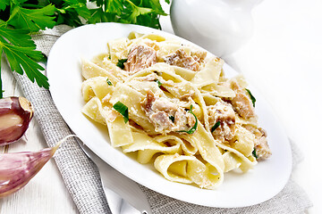 Image showing Pasta with salmon and cream on light board