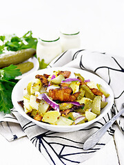 Image showing Salad potato with bacon and cucumber in plate on light board