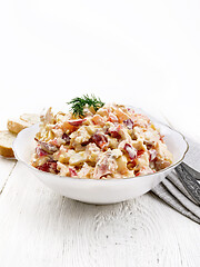 Image showing Salad with chicken and vegetables in plate on white wooden board