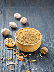 Image showing Nutmeg round in bowl on black board