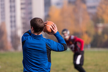 Image showing american football team with coach in action