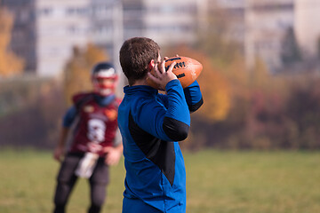 Image showing american football team with coach in action