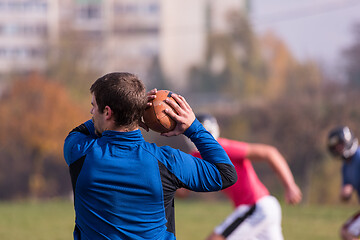 Image showing american football team with coach in action