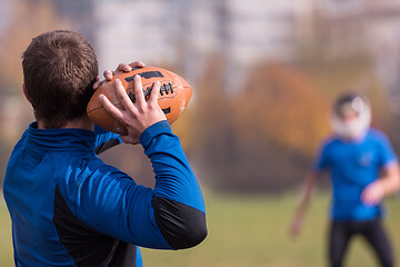 Image showing american football team with coach in action