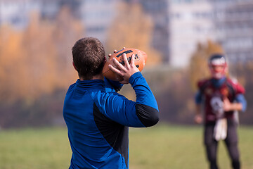 Image showing american football team with coach in action