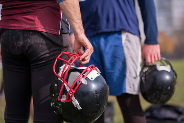 Image showing American football player holding helmet