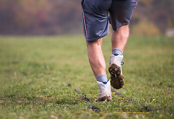 Image showing american football player exercises on ladder drills