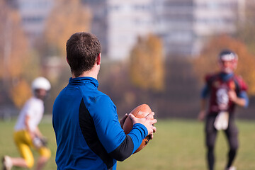 Image showing american football team with coach in action