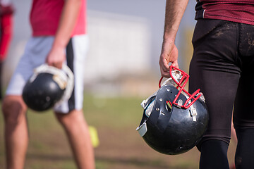 Image showing American football player holding helmet