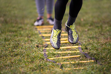 Image showing american football player exercises on ladder drills