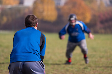 Image showing american football team with coach in action