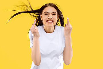 Image showing Portrait of beautiful woman isolated on yellow studio background